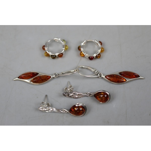 63 - 3 pairs of silver & amber earrings