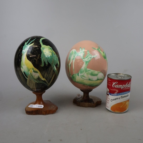 179 - 2 ostrich eggs hand decorated and signed Shelly Rowe - Approx height: 21cm