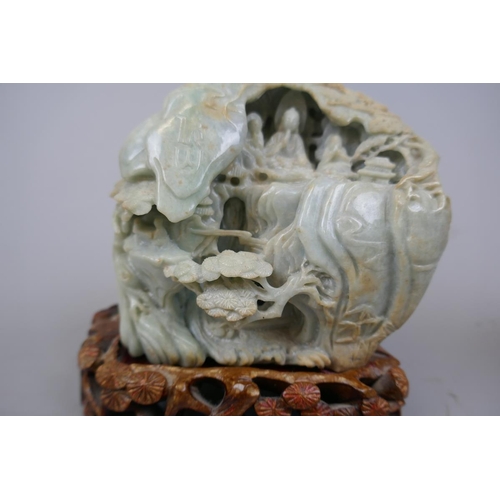 228 - Antique carved jade boulder with scholars on a bridge in a cavernous landscape to one side and Buddh... 