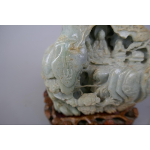 228 - Antique carved jade boulder with scholars on a bridge in a cavernous landscape to one side and Buddh... 