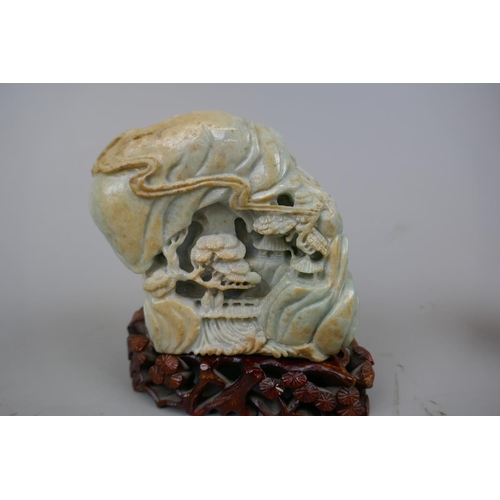 228 - Antique carved jade boulder with scholars on a bridge in a cavernous landscape to one side and Buddh... 