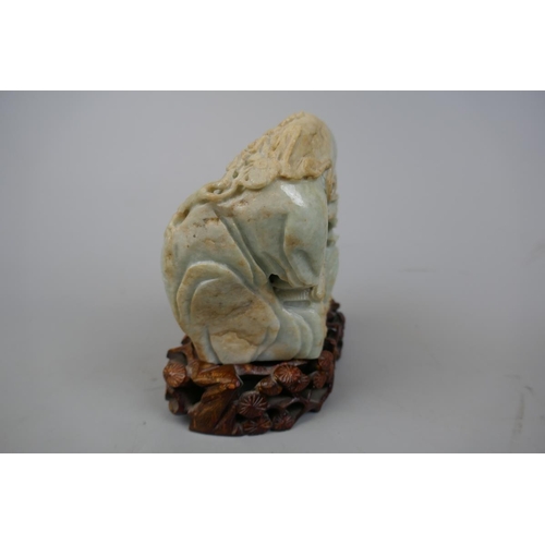 228 - Antique carved jade boulder with scholars on a bridge in a cavernous landscape to one side and Buddh... 