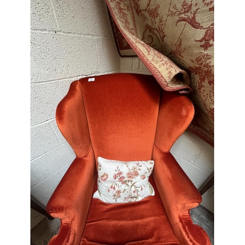 474 - Vintage Christie Tyler orange fabric Queen Anne style wing chair (labelled underneath)