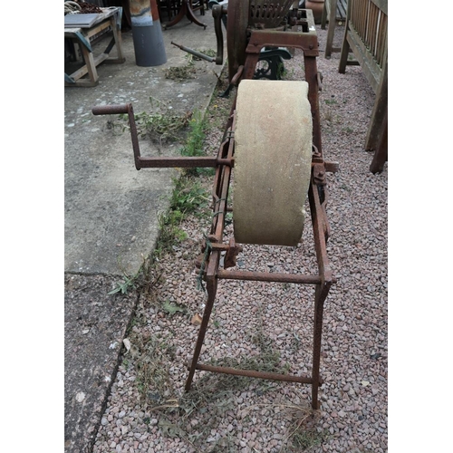 192 - Antique Cotswold limestone sharpening wheel on stand