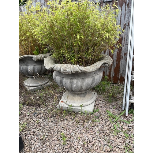 634 - Pair of very large stone planters on plinths with bamboo - Approx height: 68cm