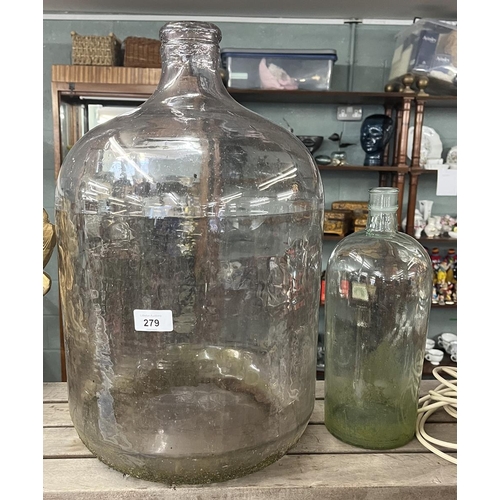 279 - Large glass carboy together with a smaller carboy