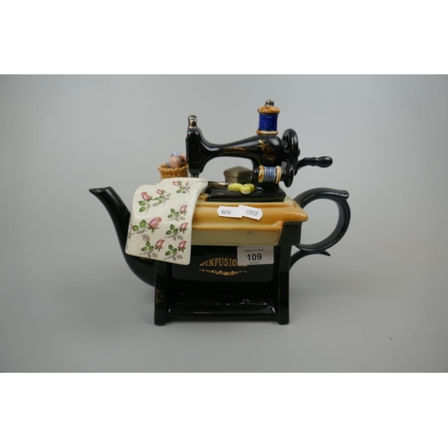 109 - Novelty ceramic teapot of a sweing machine marked Infusion