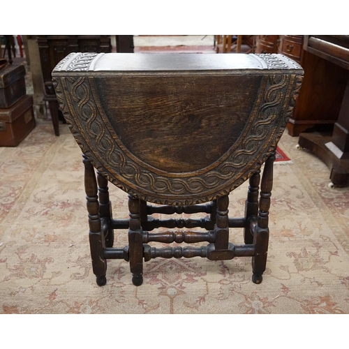 373 - Carved oak drop leaf table