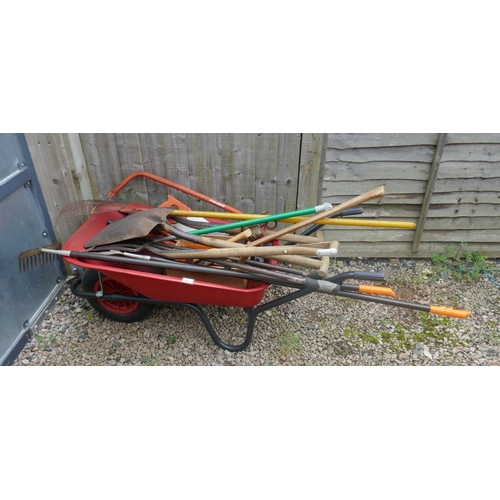 464 - Large collection of gardening tools together with a wheelbarrow