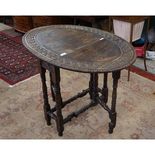 373 - Carved oak drop leaf table