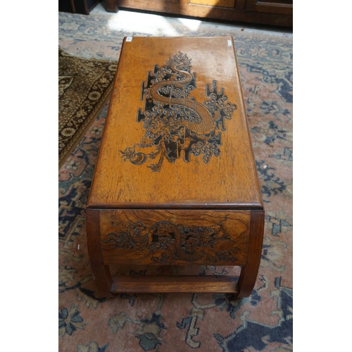 434 - Oriental coffee table carved with dragons to the top and sides