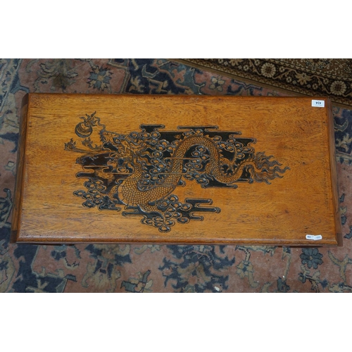 434 - Oriental coffee table carved with dragons to the top and sides