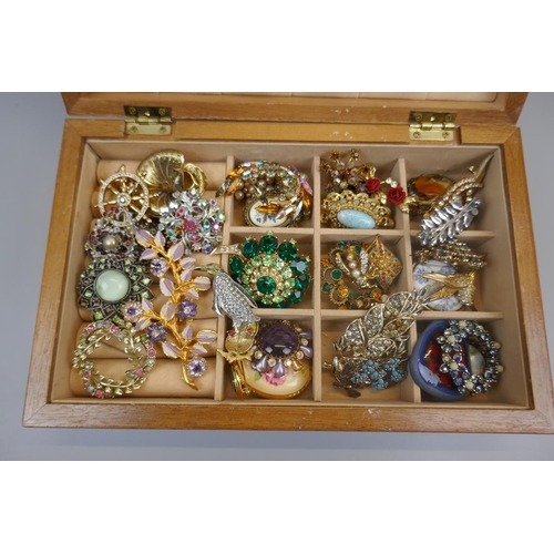 85 - Box of costume brooches