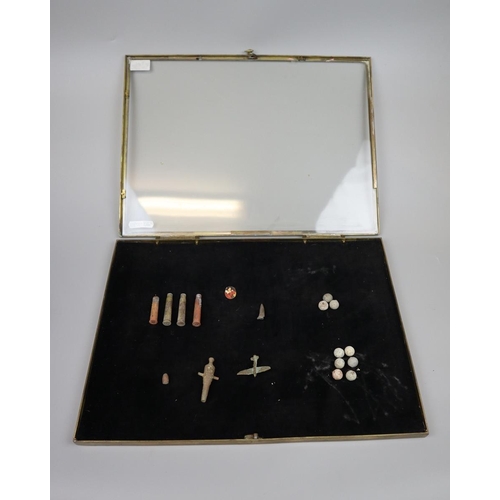 132 - Shallow brass framed table top display case containing old shells, musket balls etc.
