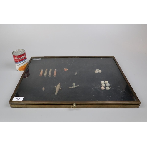 132 - Shallow brass framed table top display case containing old shells, musket balls etc.