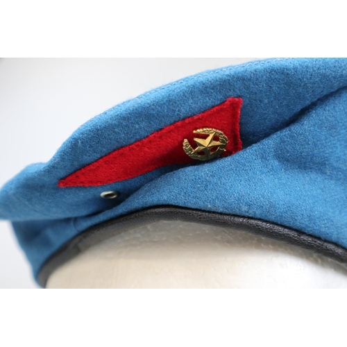 143 - Russian Paratroopers beret with badges together with an Italian Paratroopers beret with badges