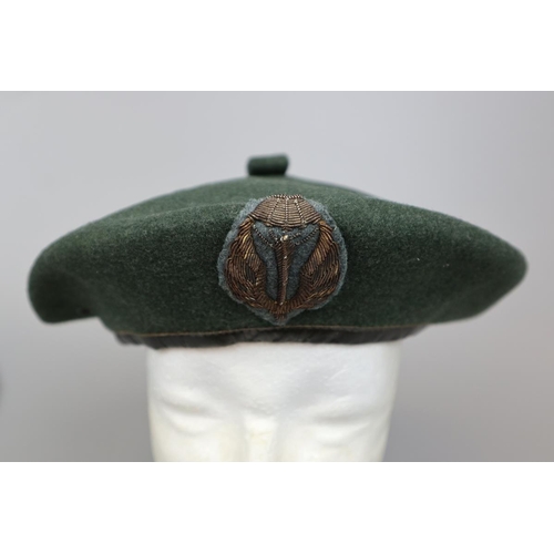 143 - Russian Paratroopers beret with badges together with an Italian Paratroopers beret with badges