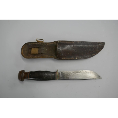 384 - Fighting knife in sheath marked KA-BAR