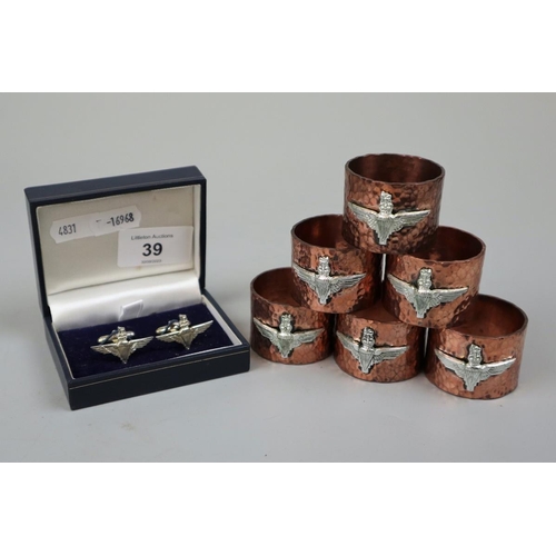39 - Hammered copper napkin rings with Para Reg badge together with a set of Para cufflinks