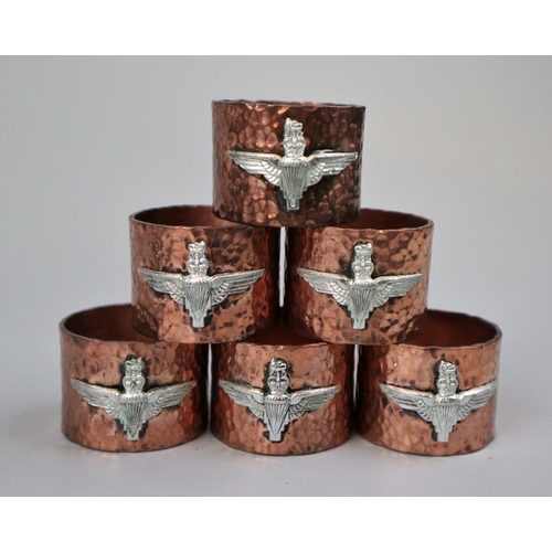 39 - Hammered copper napkin rings with Para Reg badge together with a set of Para cufflinks