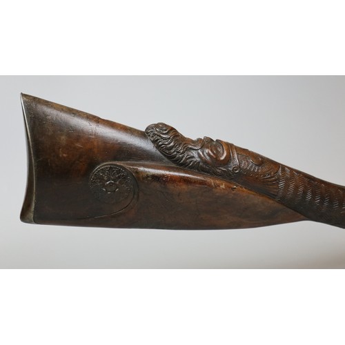 228 - Double barrel flint lock rifle with carved stock