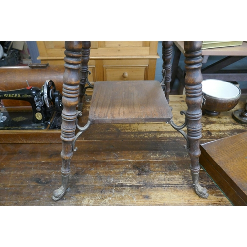 323 - Two-tier oak occasional table on interesting cast dolphin feet - Approx size: W: 61cm D: 61cm H: 74c... 