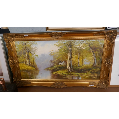 294 - Oil on board river and cottage scene signed Bates - Approx image size: 90cm x 45cm