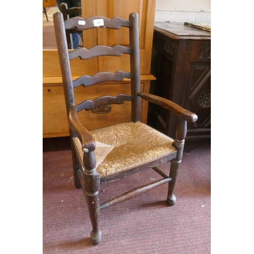 312 - Child's ladder back rush seated armchair