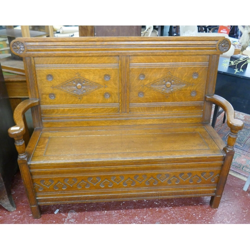 394 - Carved oak bench with integrated storage - Approx size: W: 135cm D: 49cm H: 102cm