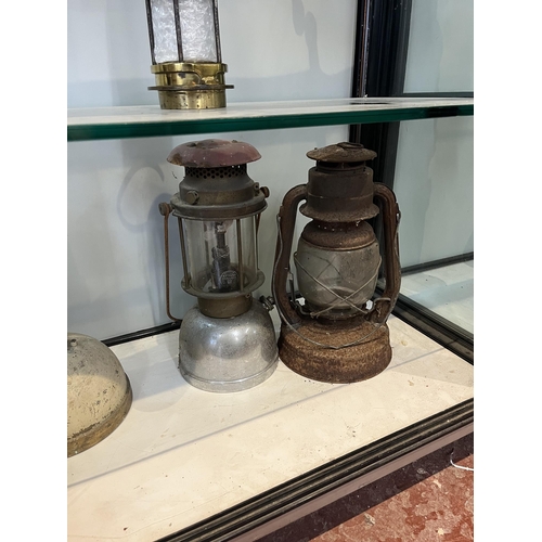 127 - Collection of paraffin lamps to include Tilley lamp