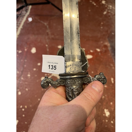 135 - Early C20th hunting dagger. Handle adorned a with hunting scene and scabbard marked with owners name... 