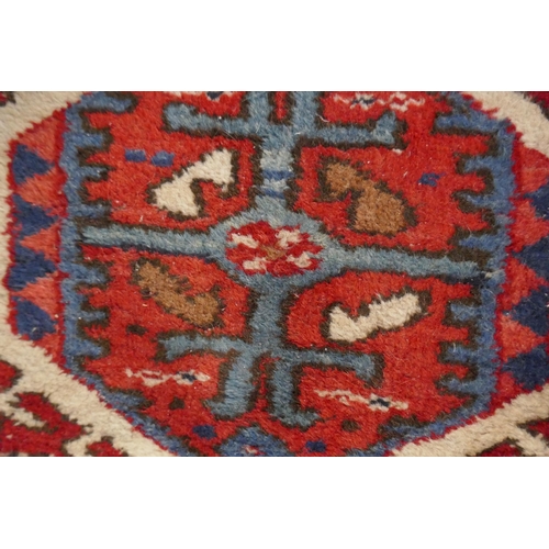 307 - Small red patterned rug - Approx size: 104cm x 136cm