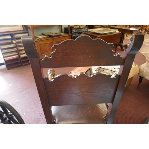 310 - Antique carved armchair adorned with lions