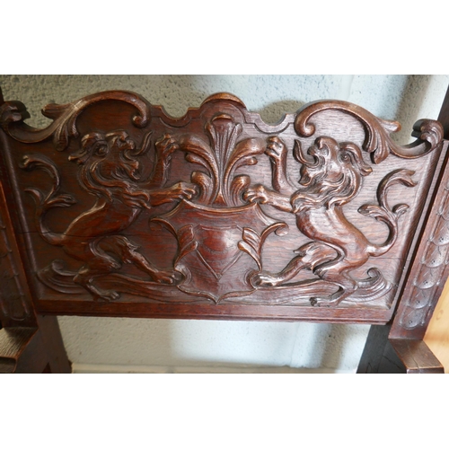 310 - Antique carved armchair adorned with lions