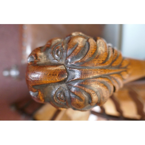 310 - Antique carved armchair adorned with lions