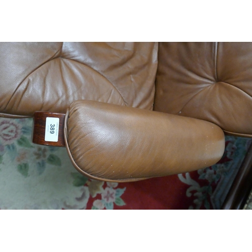 389 - Brown leather swivel easy chair