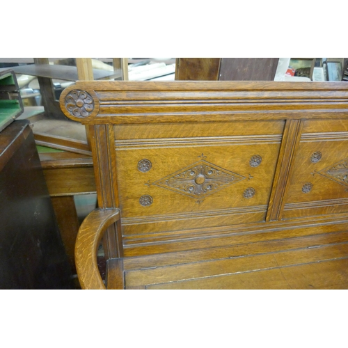 394 - Carved oak bench with integrated storage - Approx size: W: 135cm D: 49cm H: 102cm