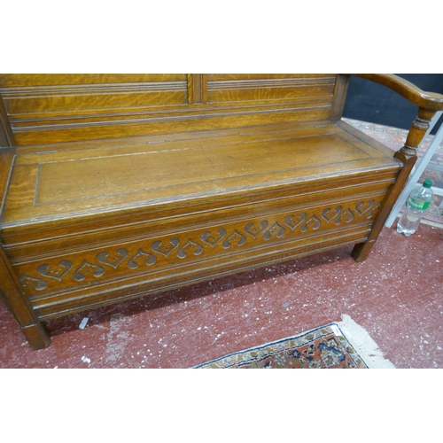 394 - Carved oak bench with integrated storage - Approx size: W: 135cm D: 49cm H: 102cm