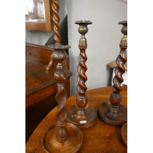 425 - 2 pairs of oak barley-twist candlesticks
