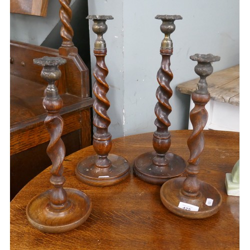 425 - 2 pairs of oak barley-twist candlesticks