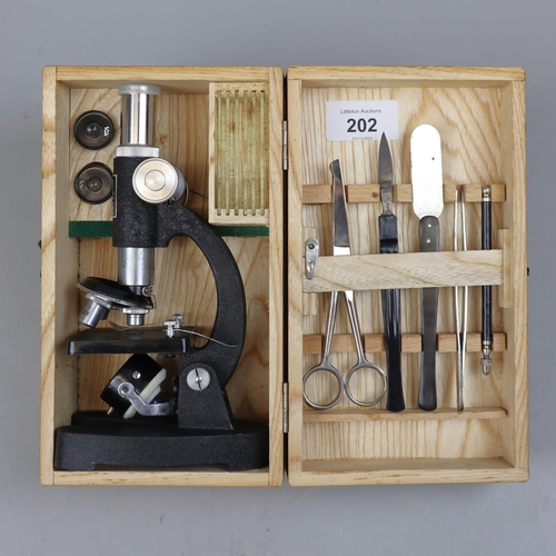 202 - Junior microscope in wooden case with slides etc