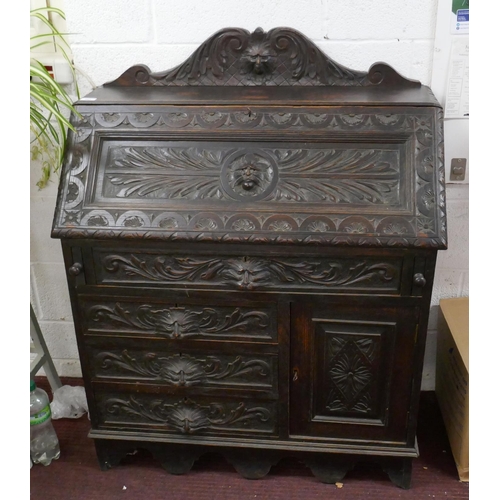 393 - Ebonised oak green man bureau 