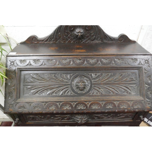 393 - Ebonised oak green man bureau 