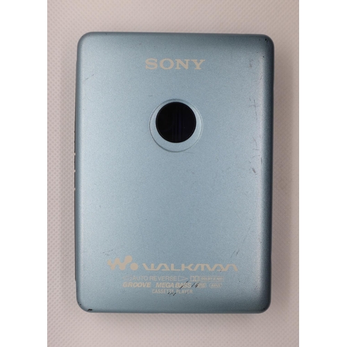 34 - Sony Walkman cassette player model no. WM-EX615/EX610 with battery, battery extender, charger, headp... 
