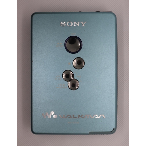 34 - Sony Walkman cassette player model no. WM-EX615/EX610 with battery, battery extender, charger, headp... 
