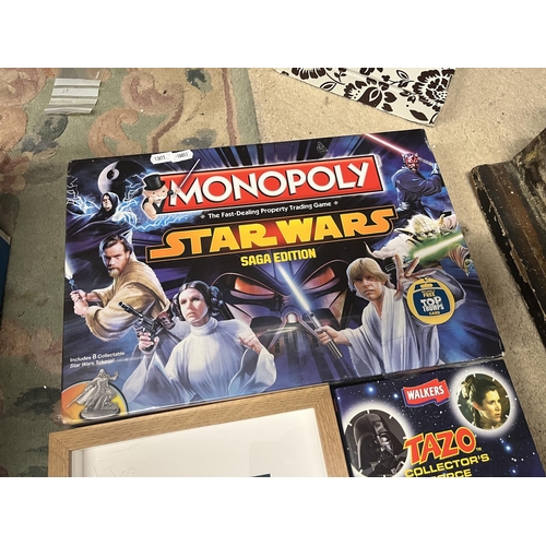 186 - Sealed Star Wars Monopoly game together with Tazo collectors pack and framed Lego droids