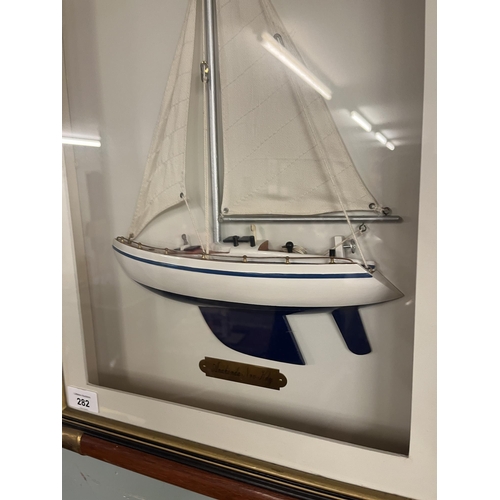 282 - Boxed framed model of a yacht