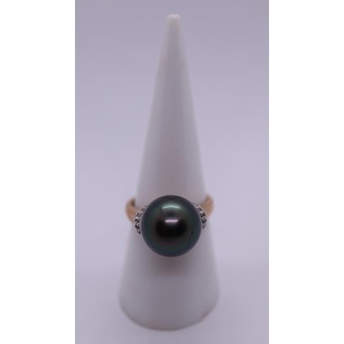 79 - 9ct gold black pearl and diamond ring - Size N