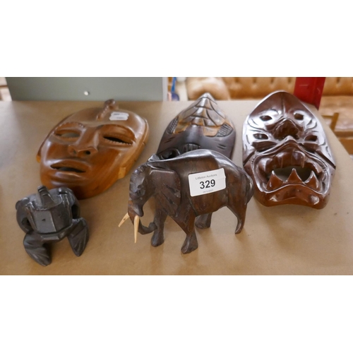 329 - 3 tribal masks together with 2 carved animals