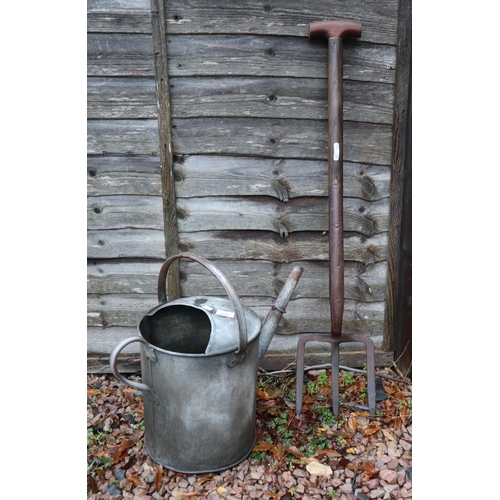 633 - Galvanised watering can together with vintage potato fork